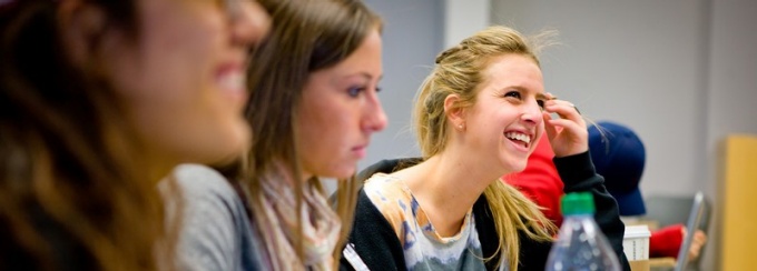 Students smile during a Communication undergraduate lecture. 