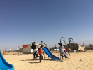 Al-Ghanem plays with children from the Azraq refugee camp near the building site. 