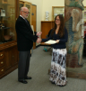 Jewels White receives recognition for her master's conferral from Donald Pollock.