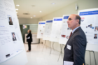 Competition judge Michael Weiner, MBA ’90, reviews the fellows’ posters during the Pitch for a Cause.