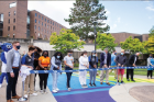 Students, staff and UB leaders line up for a ribbon-cutting ceremony in Knox Quad to celebrate “Progress Pride Paths,” the first in a series of campus public art projects, this one displaying UB’s gratitude and support for the LGBTQ community. PHOTO BY MEREDITH FORREST KULWICKI
