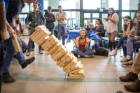 A giant Jenga tower topples to the floor of the Student Union during Engineers Week, an annual celebration. Photo by Douglas Levere.