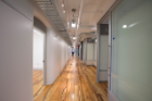 On the second and third floors, hallways were widened and brightened, while glass-walled offices share natural light and encourage interaction. Modular walls and rolling furniture allow for flexible, spontaneous changes to the building’s layout.