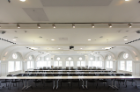 The original three-story auditorium is now a stunning 150-seat event hall and lecture space with restored moldings, arched windows and curvilinear ceiling.