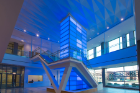 A 32-foot-tall light tower located inside the entrance lobby at Main and High streets, strikingly visible from outside the building, can be lit in virtually any color but is often seen beaming UB blue.