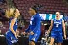 Junior guard Cierra Dillard (center) celebrates making a three-point shot with senior guard Stephanie Reid (left) as senior guard Katherine Ups joins in during the first half of the game against South Florida.