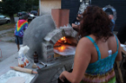 A wood-burning pizza oven forms the locus of an outdoor community space between lots.