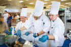 From left: UB team members Meghan Moynihan, Bronek Lis and Stephanie Balk work together during the Culinary Competition, part of the SUNY Culinary Summit.