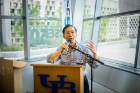 Chunming Qiao, SUNY Distinguished Professor and chair of the Department of Computer Science and Engineering, addresses a crowd at Davis Hall.