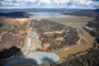 An aerial view of the Oroville Dam site and with a huge debris field in the diversion pool area just below the damaged spillway. The California Department of Water Resources gradually reduced the outflow from the spillway from 50,000 cubic feet per second (cfs) to zero on February 27, 2017. The reduction allows work to begin to remove the debris and reduce water surface elevation in the diversion pool, so the Edward Hyatt Powerplant can go operational. This will allow for better management of reservoir levels during the upcoming spring runoff season. Photo taken February 27, 2017. Dale Kolke / California Department of Water Resources