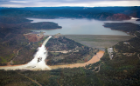 This aerial view looks east toward Oroville Dam and Lake Oroville, showing the damaged spillway with its outflow of 100,000 cubic feet per second (cfs) at the Butte County site. The California Department of Water Resources has a goal to lower the lake level by 50 feet to handle the next round of winter storms. Photo taken February 15, 2017. Dale Kolke / California Department of Water Resources