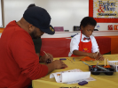Alumnus and family create art at a Strengthening Families Celebration
