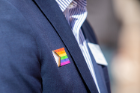 A Progress Pride Flag sticker on an event attendees jacket.Photographer: Meredith Forrest Kulwicki