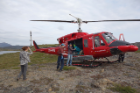 Members of the research team meet their helicopter. Left to right: UB geology undergraduate student Kayla Hollister; UB Assistant Professor of Geology Elizabeth Thomas; and Margie Turrin, education coordinator for Lamont-Doherty Earth Observatory at Columbia University. Credit: Anna McKee