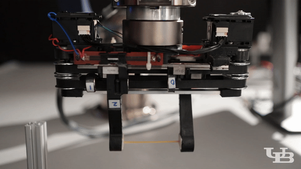robotic gripper responds to push to avoid breaking the dry spaghetti noodle it's holding