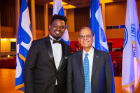 President Tripathi with Marcus Lolo, an undergraduate student who performed an original composition during President Tripathi's 10th annual State of the University address in October 2021. Photographer: Douglas Levere
