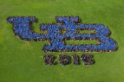 Approximately 2,300 students took part in creating the human logo, wearing UB blue-and-white T-shirts provided on site to participants. The tradition of forming the human UB began in 2004. Photo: Douglas Levere