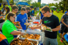 Volunteers serve a chicken barbecue dinner at the New Student Picnic, one of the marquee events of Opening Weekend. Photo: Douglas Levere