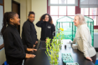 UB biologist Mary Bisson, right, talks with Hamlin Park students about the space potato project. From left: Toriana Cornwell, Shaniylah Welch and Gabriella Melendez, who call themselves the "spud launchers." Photo: Douglas Levere