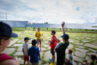 Sustainability Education Manager Erin Moscati (yellow shirt) gives campers from the UB Child Care Center a lesson on solar energy. Photo: Douglas Levere