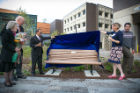 President Satish K. Tripathi and engineering dean Liesl Folks unveil a bench in Grace Plaza. Photo: Onionstudio