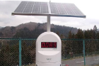 A solar-powered air dose monitor measures radiation levels at the side of a road. Photo: Misa Yasumiishi
