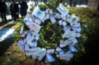 wreath accented with cards at gravesite. 