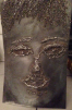 steel sculpture with surface etching that connotes a face. 