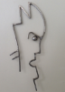 steel sculpture that resembles an angry face in profile with spikey hair. 