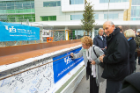Jeremy Jacobs and his wife, Margaret, sign the beam. Photo: Douglas Levere