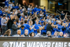 The UB cheering section, including President Satish K. Tripathi (lower left, wearing cap) goes wild at the women's game. Photo: Paul Hokanson