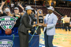 Women's coach Felisha Legette-Jack and Athletics Director Allen Greene hold the MAC championship trophy. Photo: Paul Hokanson