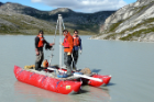 Members of the research team collect lake sediment cores from a coring platform in western Greenland. From left: Stefan Truex (at the time, a UB undergraduate geology student, now at Aztech Technologies), Nicolás Young (at the time, a UB geology PhD student, now an assistant research professor at Lamont Doherty Earth Observatory) and Sam Kelley (at the time, a UB geology PhD student, now a postdoctoral fellow at Waterloo University). Photo: Jason Briner