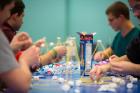 In a team-building exercise, students use spaghetti and marshmallows to build model skyscrapers. Photo: Douglas Levere.