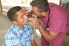 Medical student Aman Cheema examines a patient with vision abnormalities.