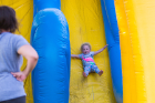 Kenedy Stockwell takes a ride down the slide as her mother, Jessica Stockwell, watches.