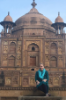 Kayleigh Reed sits in front of Khusro Bagh, a large walled garden and burial complex in Allahabad, India.