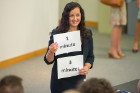Hadar Borden, program director for the Blackstone LaunchPad at UB, holds cards that will let the pitch participants know how much time they have left for their presentation. Blackstone LaunchPad is a partner in the Social Impact Fellows Program along with the School of Management and the School of Social Work.