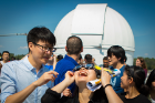 Jessica Huang excitedly observes the eclipse from the roof of Fronczak Hall, one of the more popular eclipse-viewing spots on the North Campus.