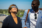 Nancy Paton, vice president for communications, wears safety glasses to view the eclipse. At her left is Allen Greene, director of athletics.