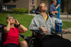 Sue Nuemeister and Tim McCarthy observe the eclipse from the ground on the North Campus.