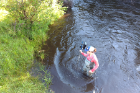 Kristin Thomas, aquatic ecologist for Michigan Trout Unlimited, an organization that has been supportive of the new project, measures stream discharge along the lower section of the Boyne River. Photo: Damon Hall