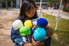 Michelle Lucero, a diversity advocate, carries yarn for the UB Unity Project, organized by the Intercultural & Diversity Center, on the Student Union Field on the North Campus.
