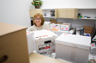 Health sciences senior staff assistant Bernadine Macy seems unfazed at the prospect of unpacking all these boxes. 