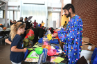 Pharmacy student Nick Bhasin — dressed as "a microbe, U. Bufalonius" — gives a demonstration on antibiotics and how they can be harmful to one's gastrointestinal tract and immune system. At his table are siblings Mia Muscato, age 9, and Nicholas Muscato (teenage mutant turtle), age 6.