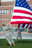 ROTC cadets unfurl the flag.