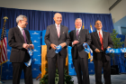 From left: UB Provost Charles Zukoski, Jeremy Jacobs, Michael Cain and Satish Tripathi, each with "pieces of UB" from the ceremonial ribbon-cutting. Photo: Douglas Levere