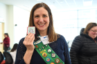 Lauren Kuwik, clinical instructor in the Department of Medicine, proudly wears her Girl Scout sash and holds a special patch Scouts received for attending the event.