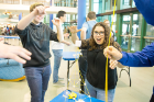 Ariana Allman (center), a senior biomedical engineering major, watches as her teammate uses a measuring tape to measure the height of the tower.