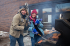 Two hardy souls, Travis Nelson (left) and Susan Bratcher, load up the grill. Photo: Meredith Forrest Kulwicki